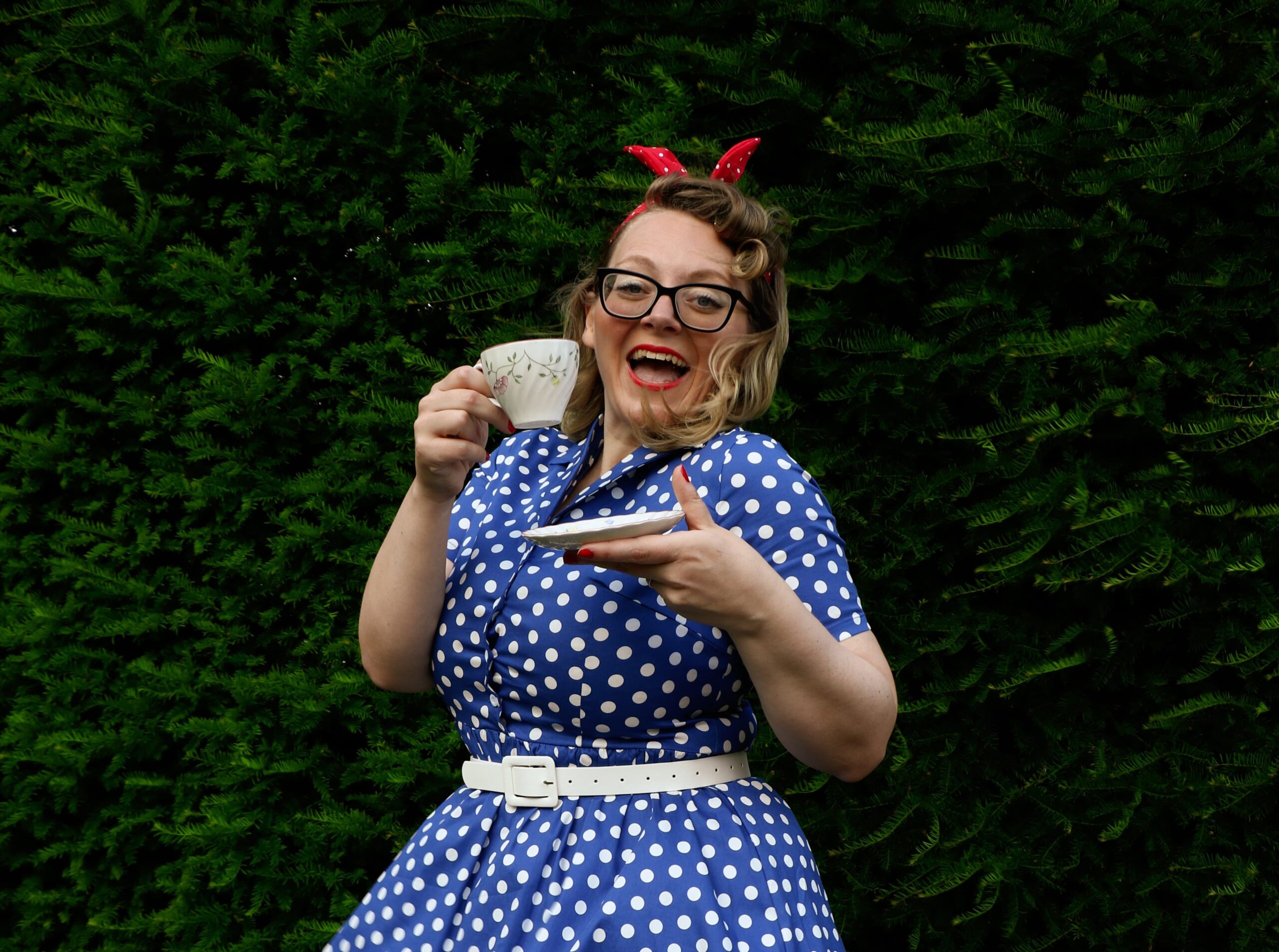 Adele performing in a blue and white polka-dot vintage dress